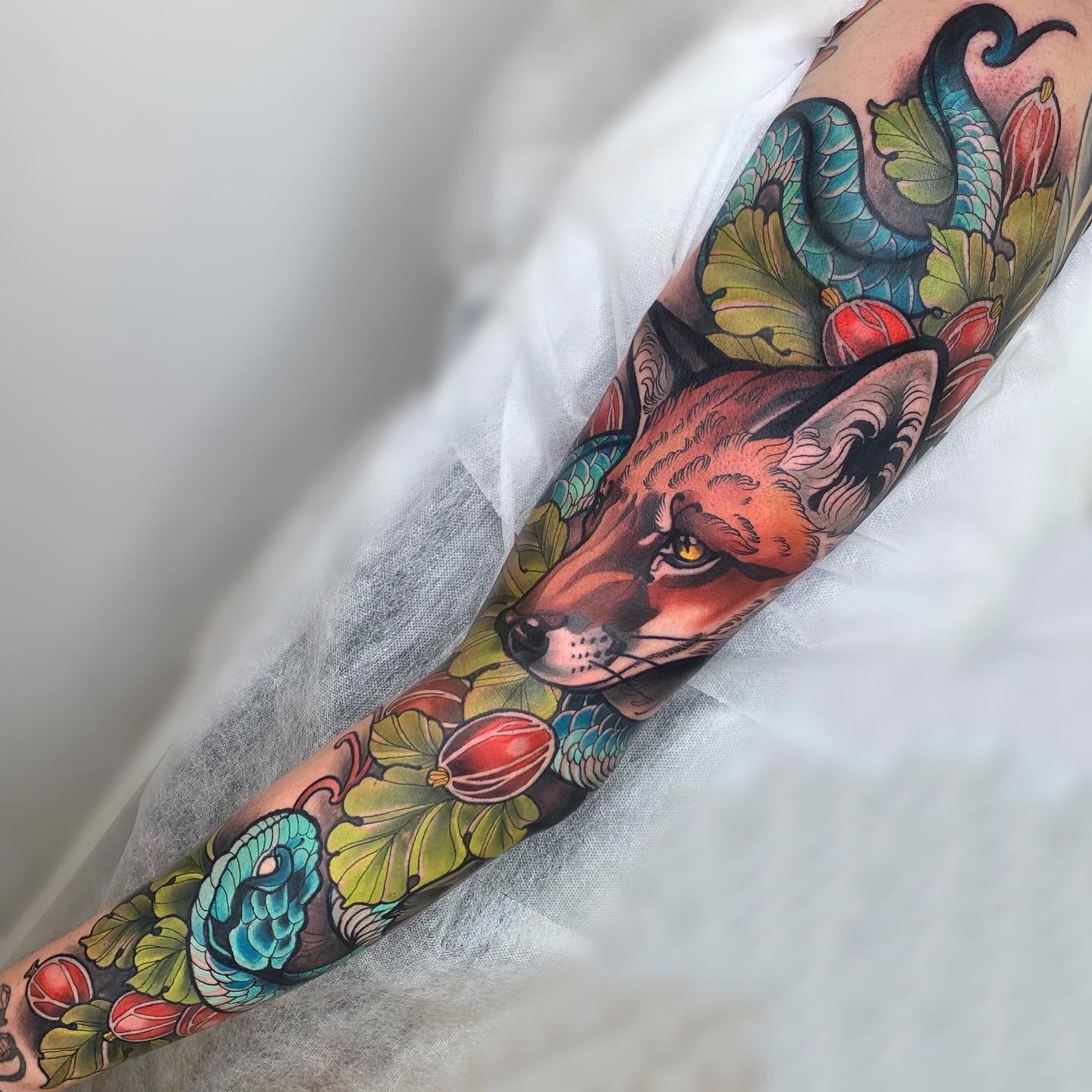 Multi-coloured full sleeve arm tattoo